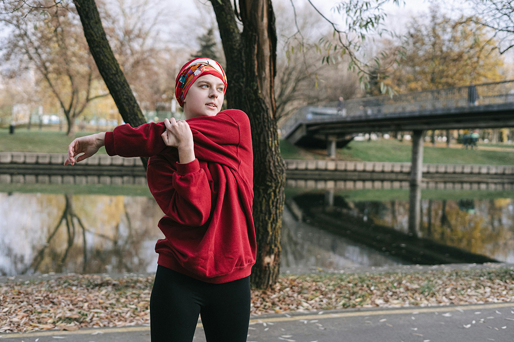 pexels-ivan-samkov-6436020_1000px A Woman in Red Sweater Warming Up in the Morning